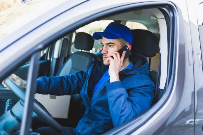 deliveryman-having-phone-call-car_23-2147767588-696x464